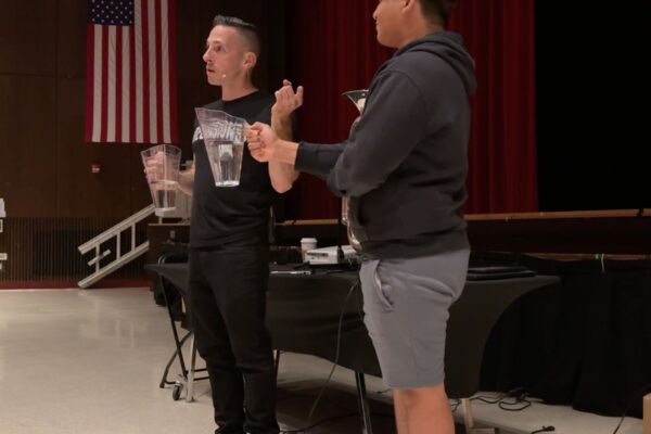 Youth Motivational Speaker Kevin Mecchella with a student volunteer at East Islip high school